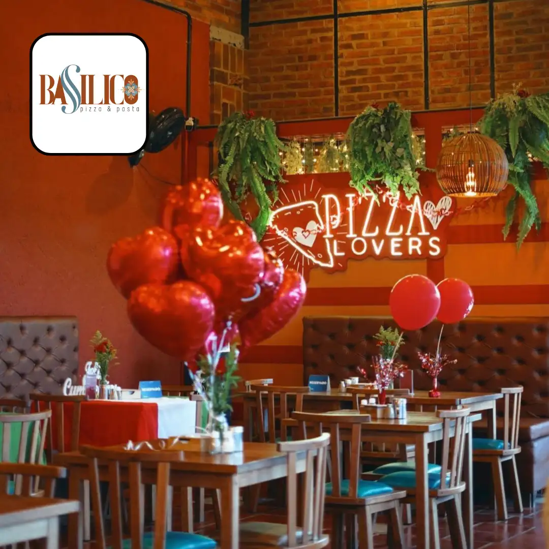 Restaurante con sillas azules mesas cafés globos y letrero de pizza en neon